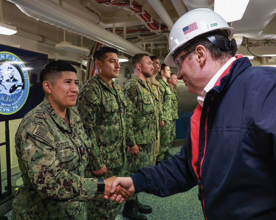 Navy Secretary John Phelan recognizes Aviation Ordnanceman 2nd Class Ariadna Coyotzi for hard work aboard Pre-Commissioning Unit John F. Kennedy, April 16, 2025 (U.S. Navy/Brittney Camacho-Pietri)